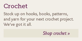Crochet hooks, books, patterns and yarn.
